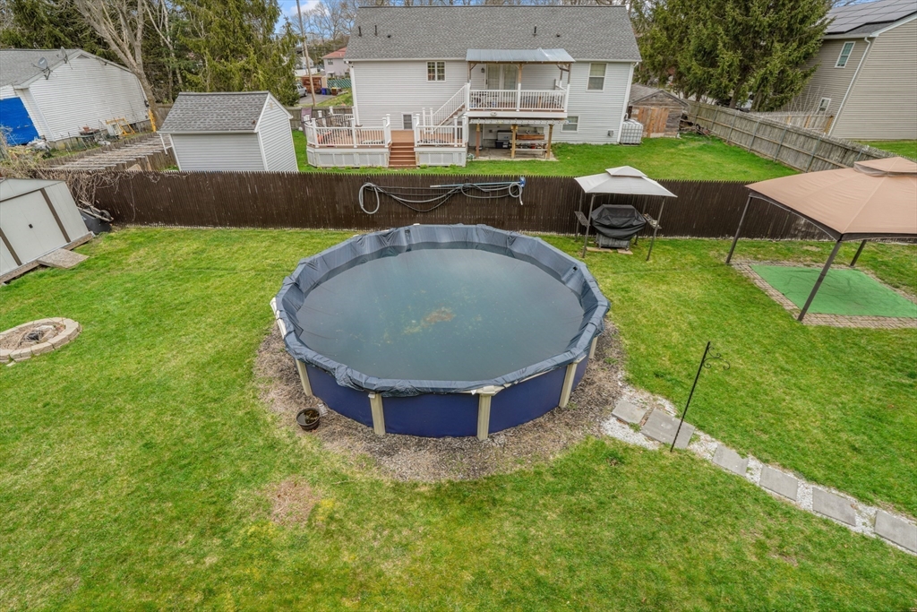 500 Hancock Street Fall River, MA 02721 - Photo 28 of 33 a view of a backyard with table and chairs under an umbrella