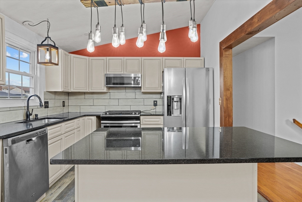 500 Hancock Street Fall River, MA 02721 - Photo 4 of 33 a kitchen with stainless steel appliances granite countertop a sink a stove and a refrigerator