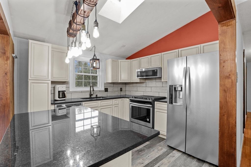 500 Hancock Street Fall River, MA 02721 - Photo 6 of 33 a kitchen with stainless steel appliances granite countertop a refrigerator a stove and a sink with wooden floor