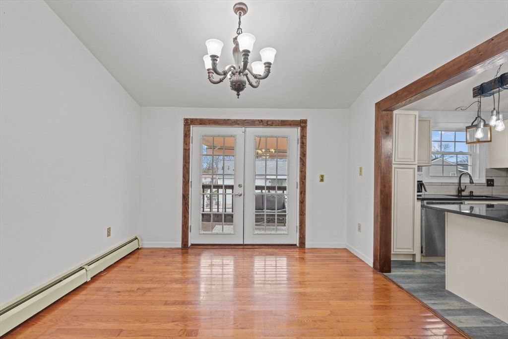 500 Hancock Street Fall River, MA 02721 - Photo 8 of 33 a view of a room with wooden floor and a kitchen