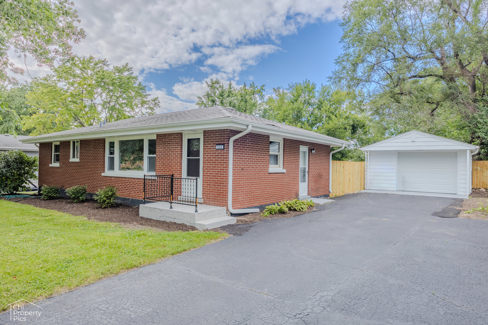 752 Rolling Drive Lisle, IL 60532 - Photo 1 of 37 front view of house with a yard and potted plants