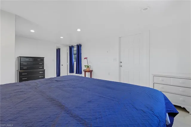 a view of a bedroom with closet and cabinet