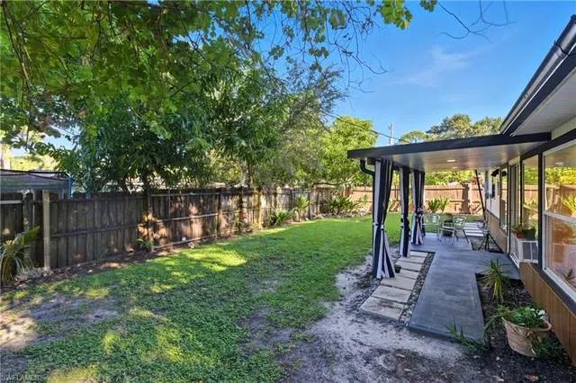 a view of a house with swimming pool and sitting area