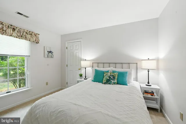 a bedroom with a bed and a night stand