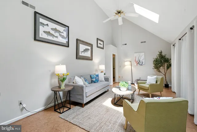 a living room with furniture and a dining table