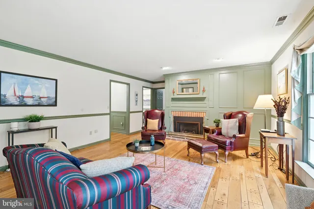 a living room with furniture fireplace and rug