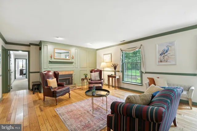 a living room with furniture two night stand and a window