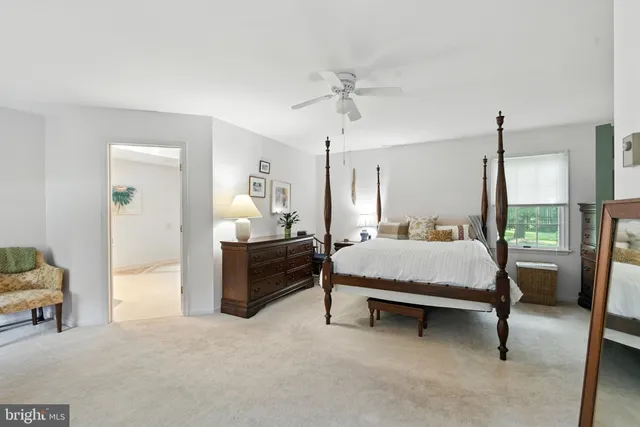 a spacious bedroom with a bed and a chandelier