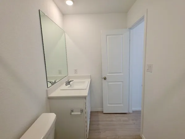 a bathroom with a sink toilet and mirror