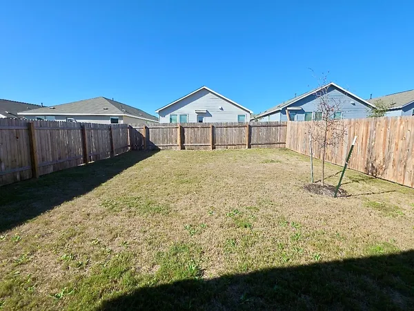 a view of a backyard of the house