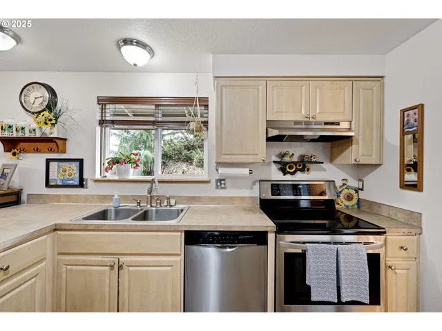 a kitchen with stainless steel appliances a sink stove and cabinets