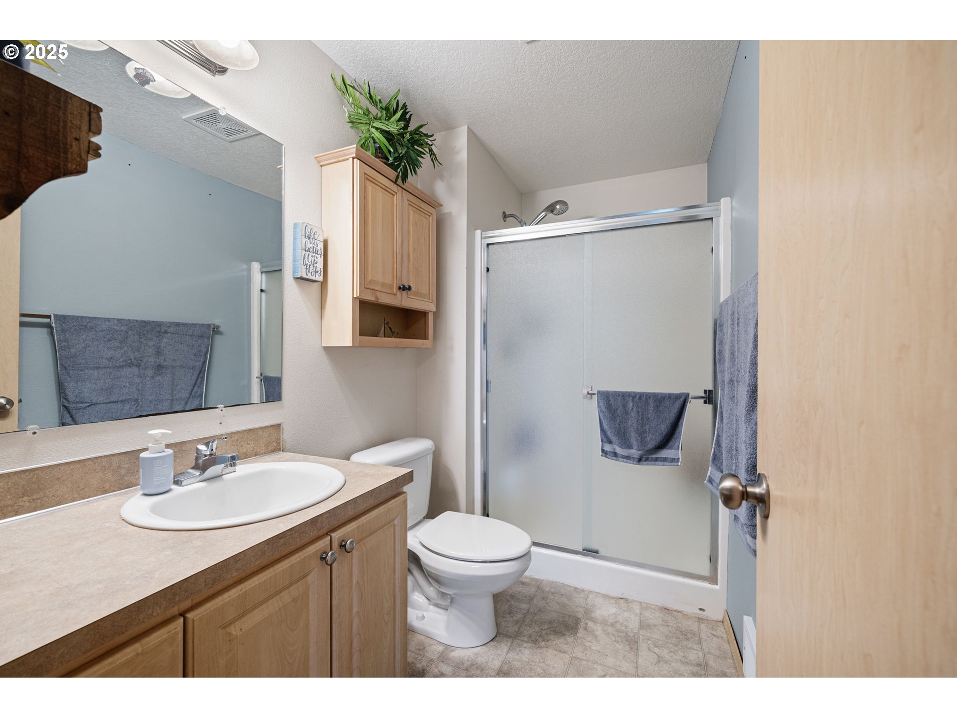 32968 Camas Swale Road Creswell, OR 97426 - Photo 25 of 44 a bathroom with a sink toilet a mirror and shower