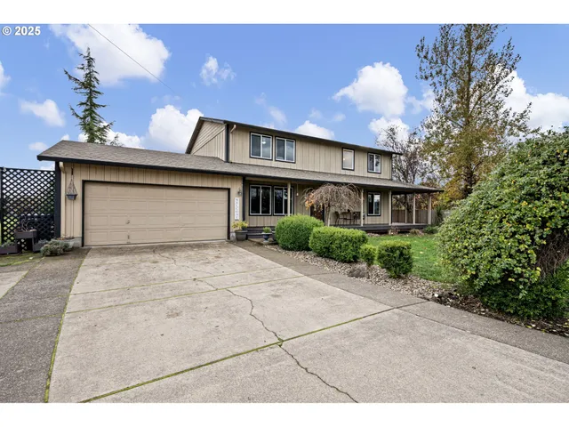a front view of a house with a yard and a garage