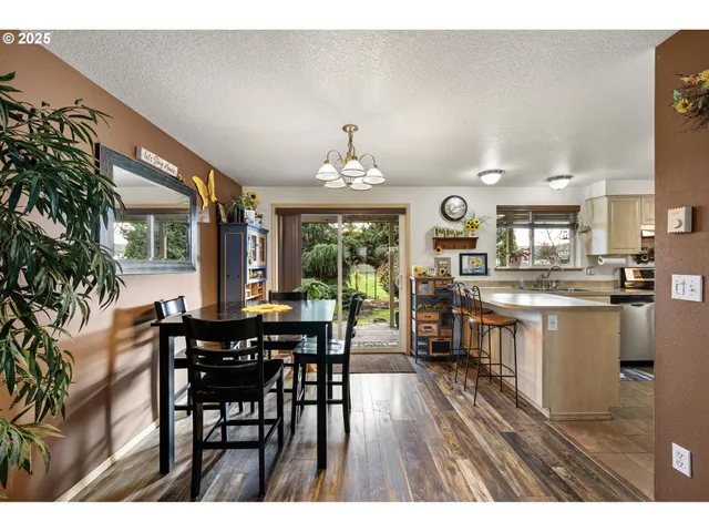 a open kitchen with kitchen island a dining table and chairs