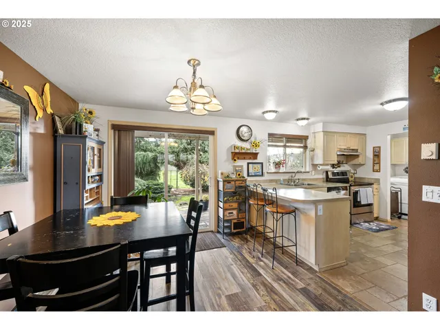 a kitchen with a table chairs and flat screen tv