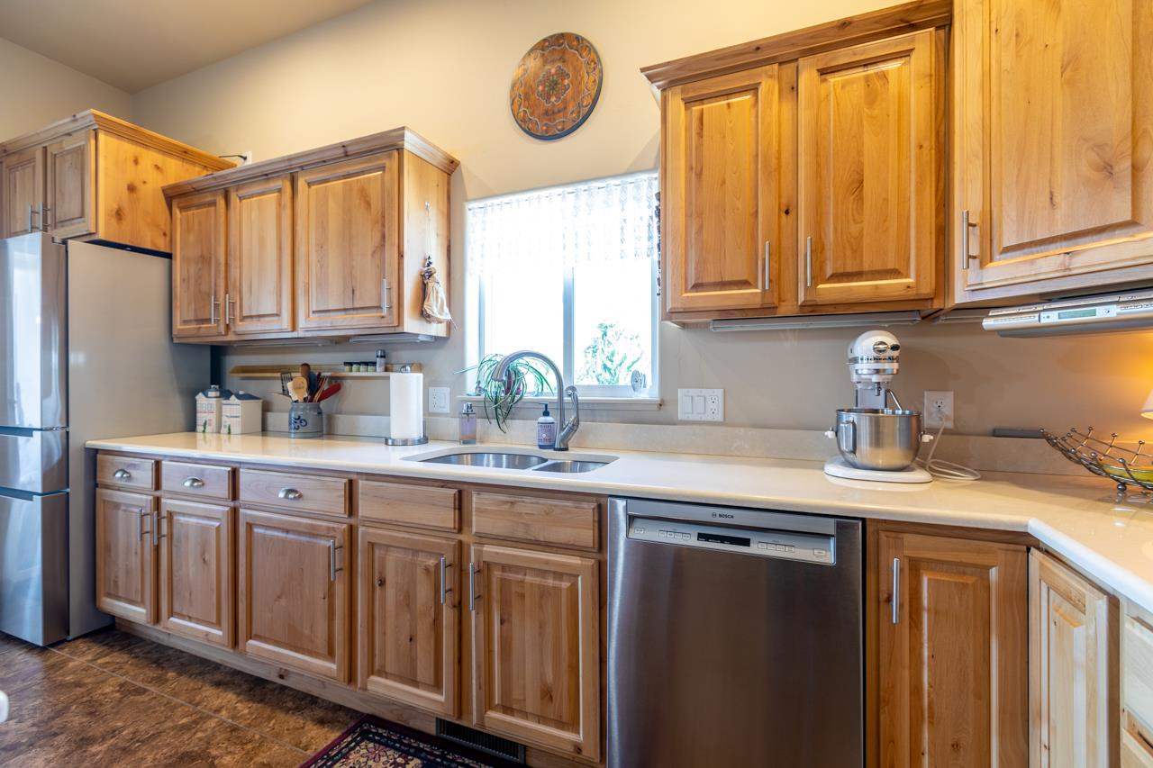 962 Hickory Street Fruita, CO 81521 - Photo 8 of 35 a kitchen with stainless steel appliances granite countertop a sink and cabinets