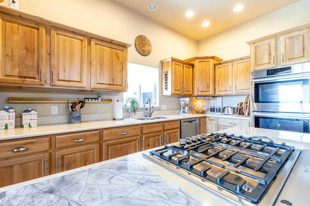 962 Hickory Street Fruita, CO 81521 - Photo 10 of 35 a kitchen with a large stove a sink dishwasher and cabinets with wooden floor