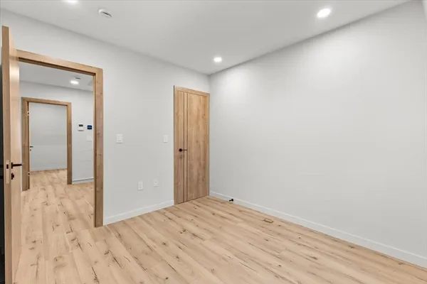 a view of a room with wooden floor and bathroom