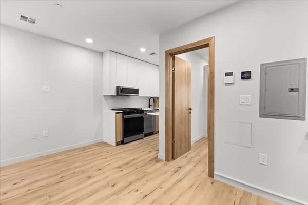 a kitchen with stainless steel appliances a refrigerator and a stove top oven