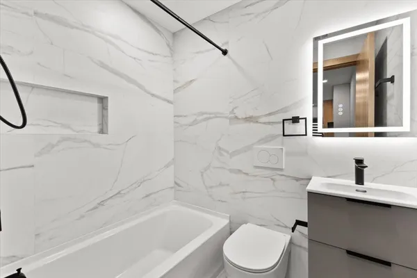 a bathroom with a sink toilet and shower