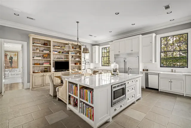 a very nice looking open dining room with kitchen island furniture a large window and kitchen view