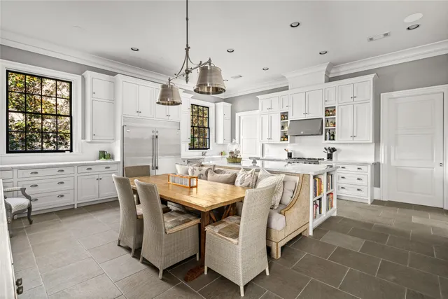 a kitchen with granite countertop white cabinets and window