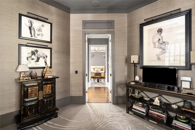 a dining room with chandelier and wooden floor