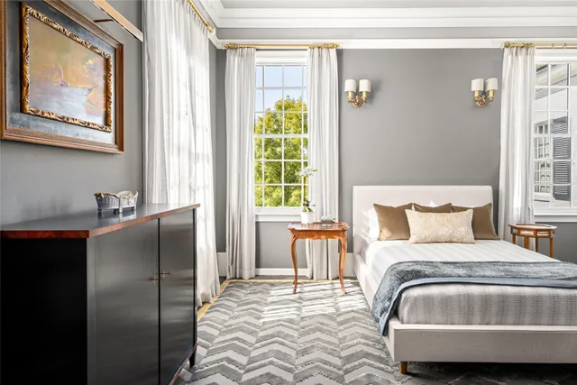 a white bath tub sitting next to a white cabinet