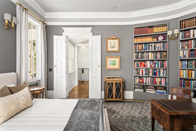 a bedroom with furniture and a book shelf