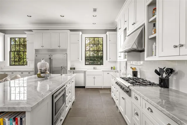 a kitchen with stove a sink dishwasher and cabinets with wooden floor