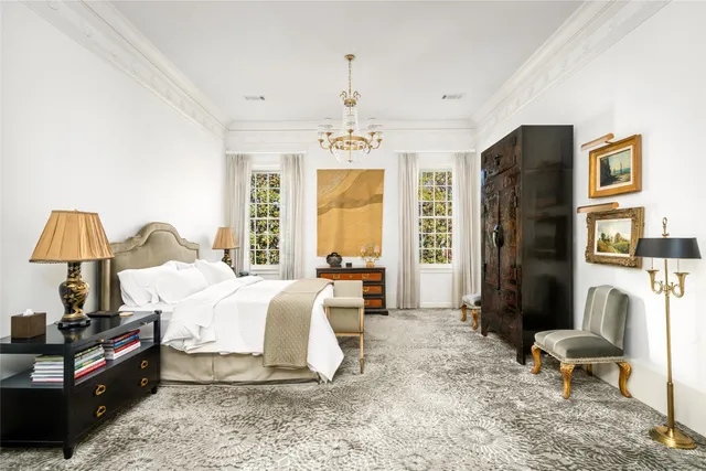 a bed room with a bed and a chair