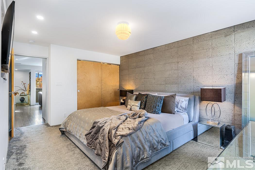 860 South Center Street Reno, NV 89501 - Photo 23 of 36 a bedroom with a bed and a chandelier
