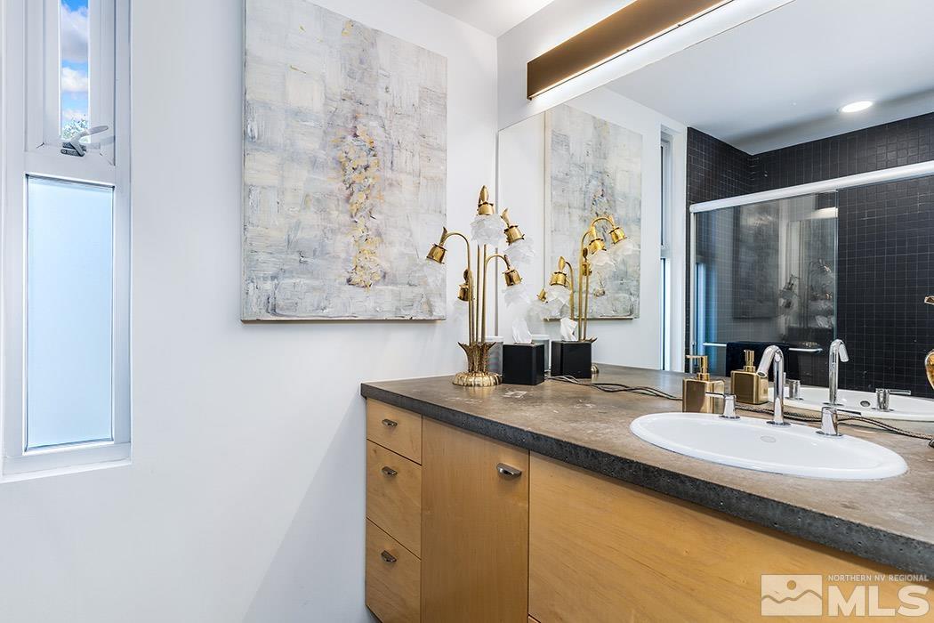 860 South Center Street Reno, NV 89501 - Photo 24 of 36 a bathroom with a granite countertop sink and a mirror
