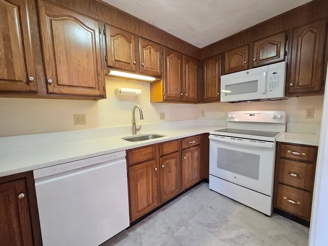 a kitchen with cabinets stainless steel appliances and a sink