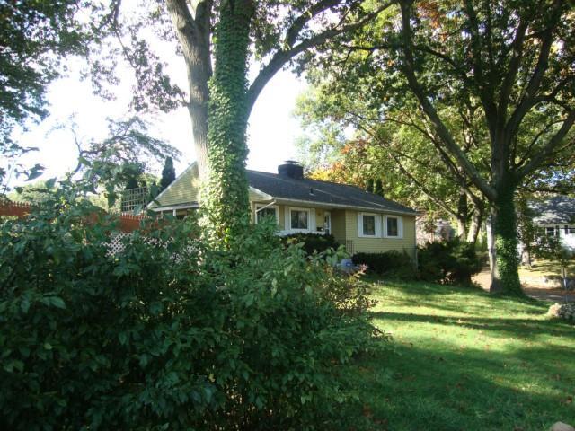 8 Hollow Tree Road Norwalk, CT 06854 - Photo 1 of 1 a front view of a house with yard and green space