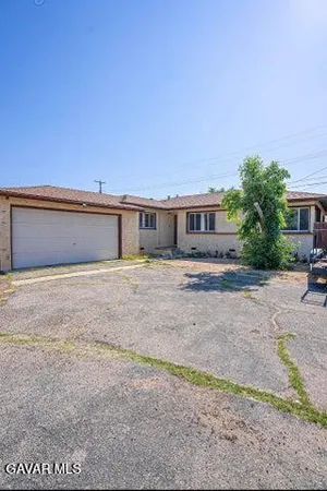 a front view of a house with a yard and a garage