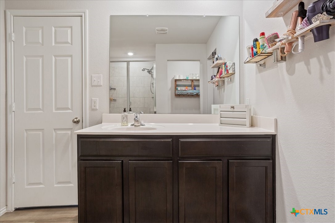 1000 Velvet Court Troy, TX 76579 - Photo 16 of 25 a bathroom with a sink vanity and a mirror