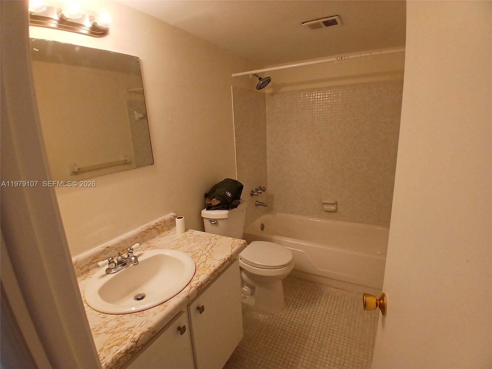 11273 Southwest 88th Street, Unit 114J Miami, FL 33176 - Photo 11 of 19 a bathroom with a sink a toilet and shower