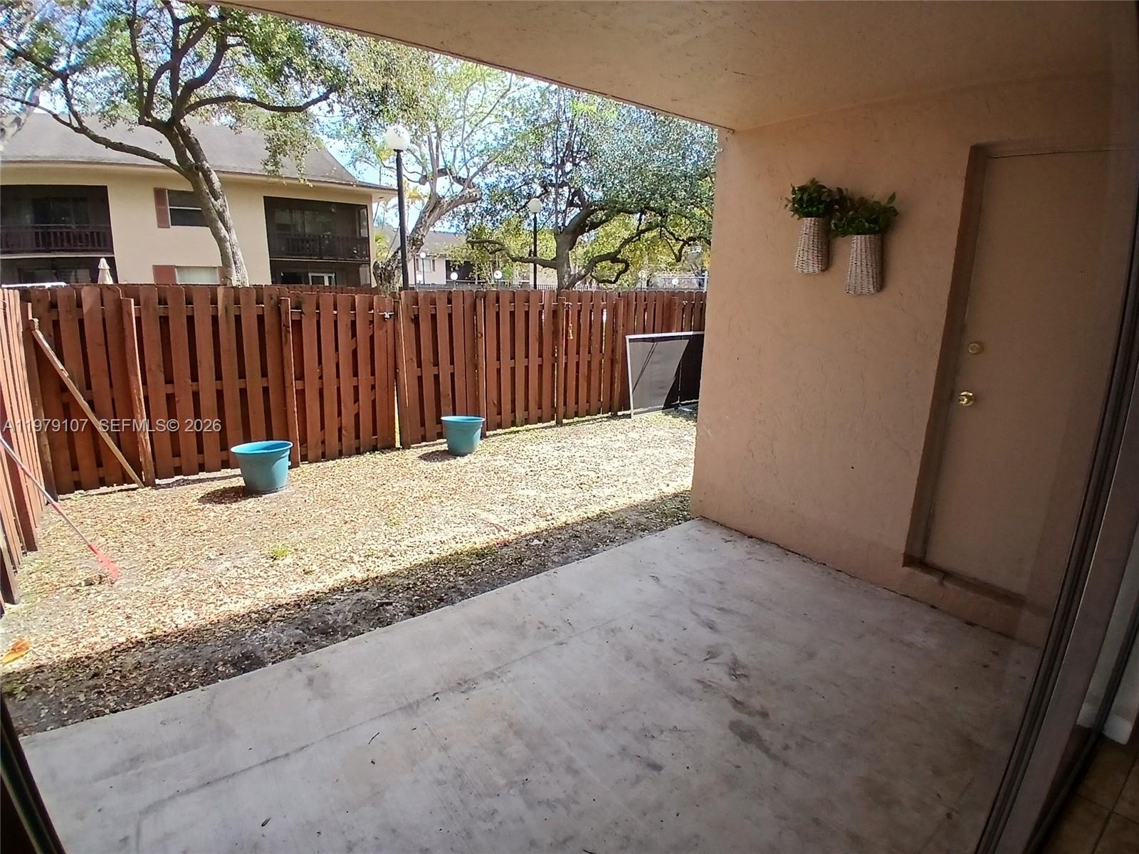 11273 Southwest 88th Street, Unit 114J Miami, FL 33176 - Photo 12 of 19 a view of a backyard of the house