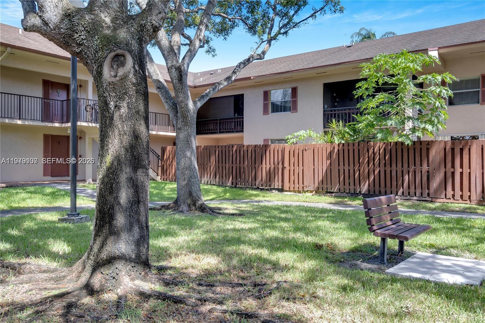 11273 Southwest 88th Street, Unit 114J Miami, FL 33176 - Photo 15 of 19 a backyard of a house with table and chairs