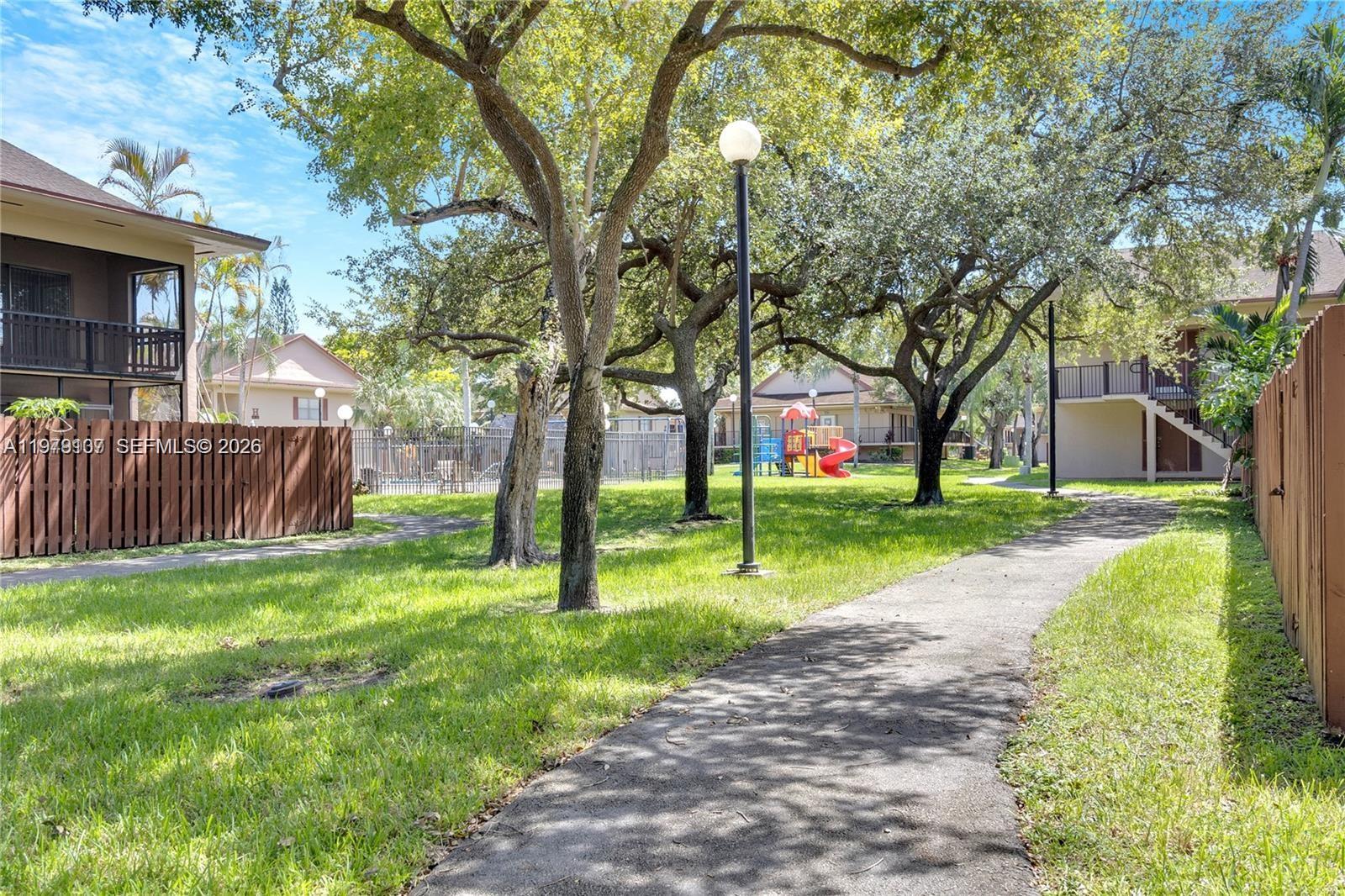 11273 Southwest 88th Street, Unit 114J Miami, FL 33176 - Photo 17 of 19 a view of a backyard with wooden fence