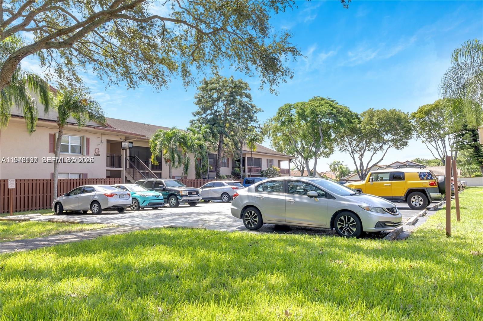 11273 Southwest 88th Street, Unit 114J Miami, FL 33176 - Photo 19 of 19 a front view of a house with garden and patio