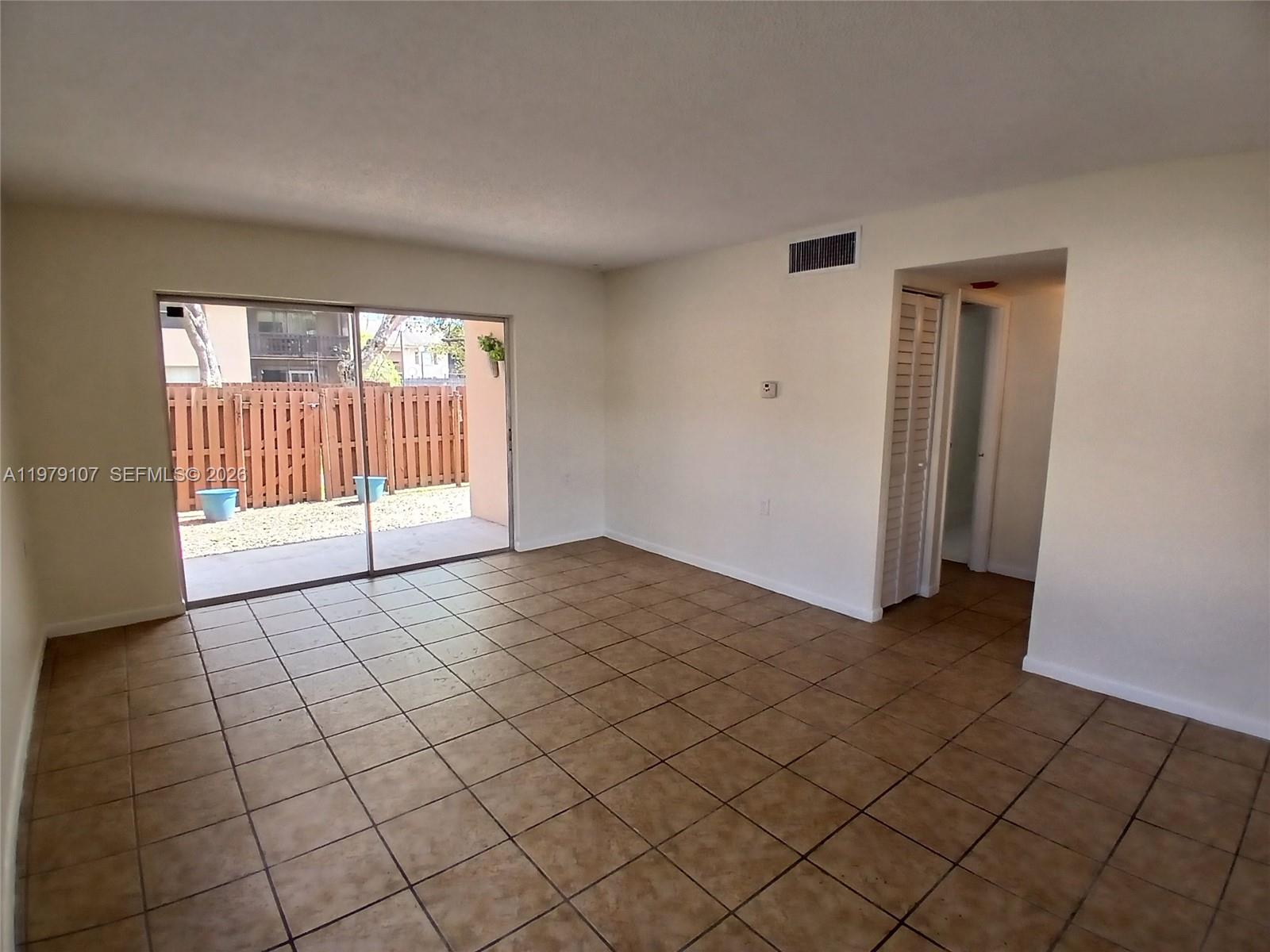 11273 Southwest 88th Street, Unit 114J Miami, FL 33176 - Photo 5 of 19 a view of empty room with wooden floor