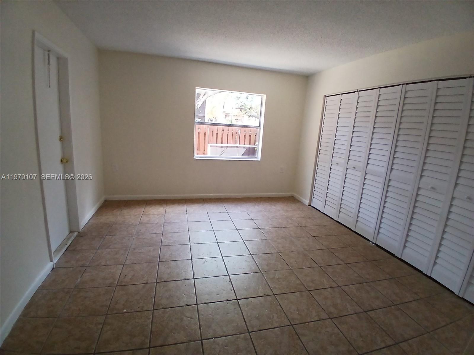 11273 Southwest 88th Street, Unit 114J Miami, FL 33176 - Photo 7 of 19 a view of an empty room and window