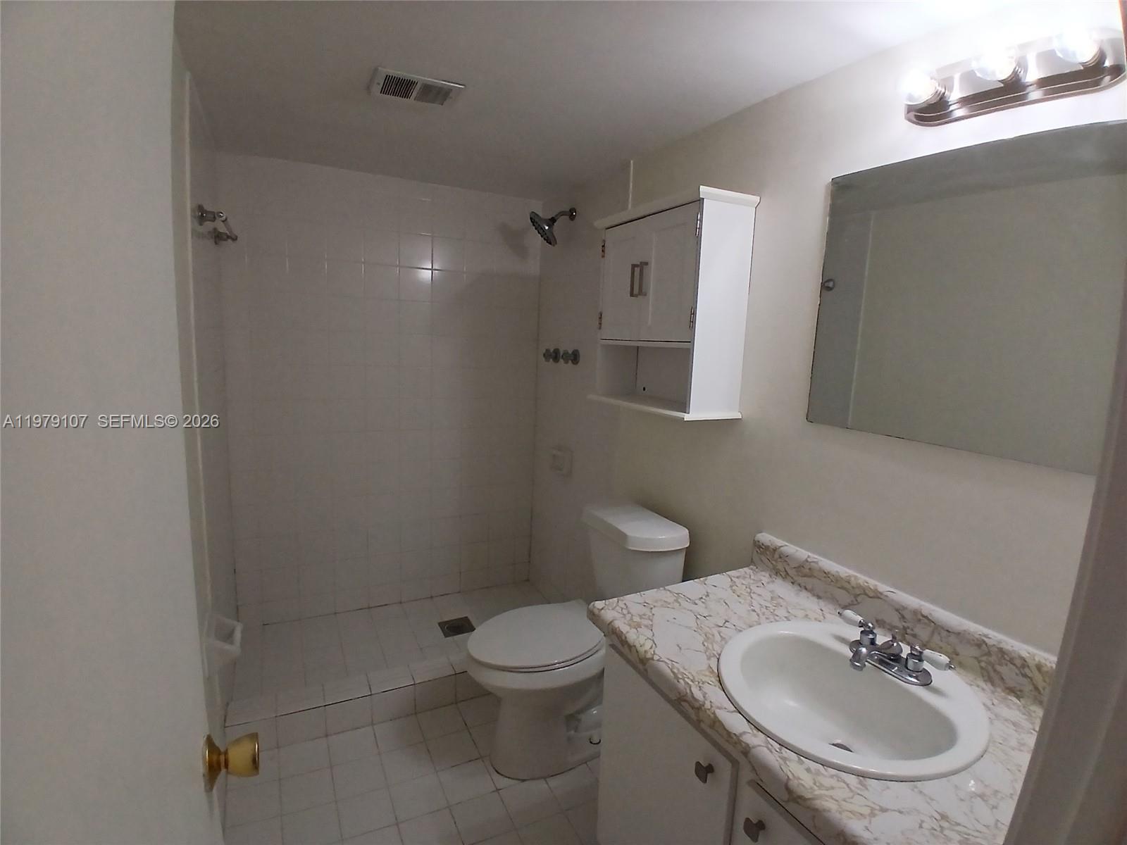 11273 Southwest 88th Street, Unit 114J Miami, FL 33176 - Photo 9 of 19 a bathroom with a sink toilet and a mirror