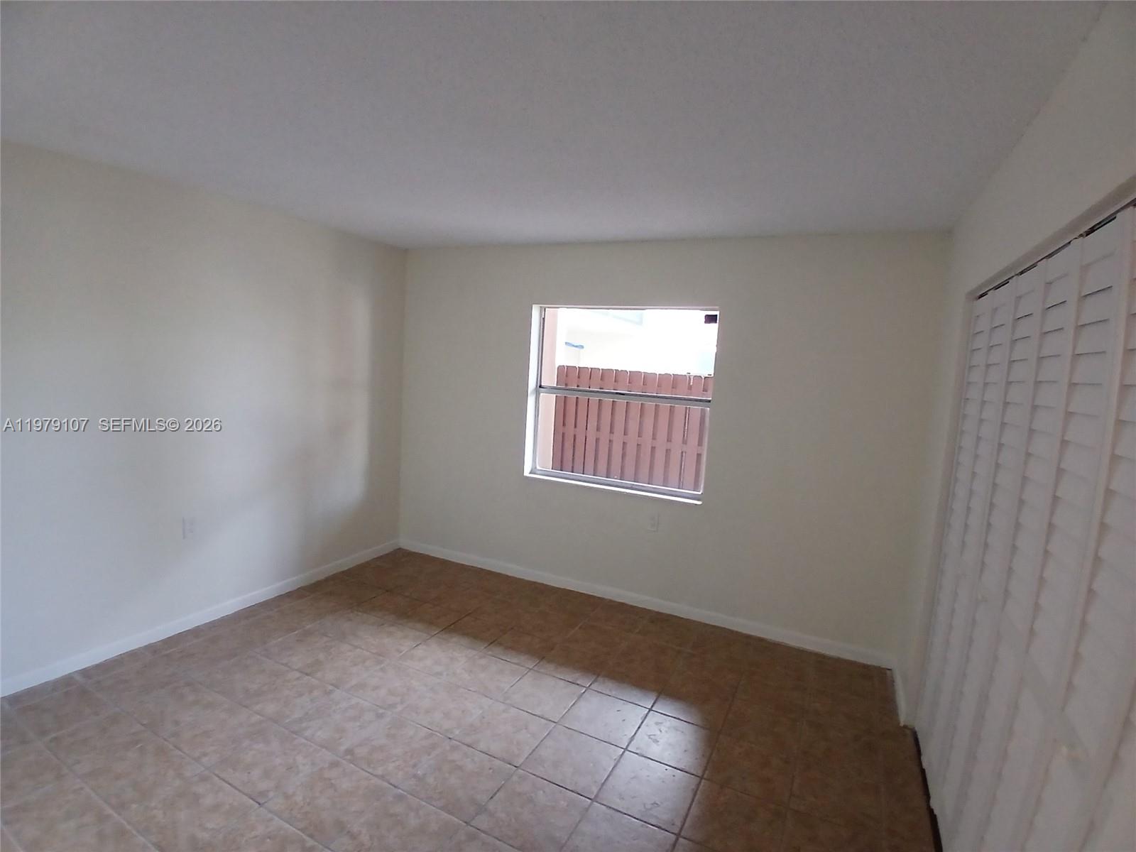 11273 Southwest 88th Street, Unit 114J Miami, FL 33176 - Photo 10 of 19 an empty room with windows