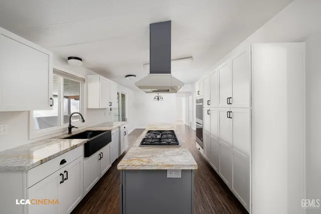 a kitchen with granite countertop stove a sink and a refrigerator