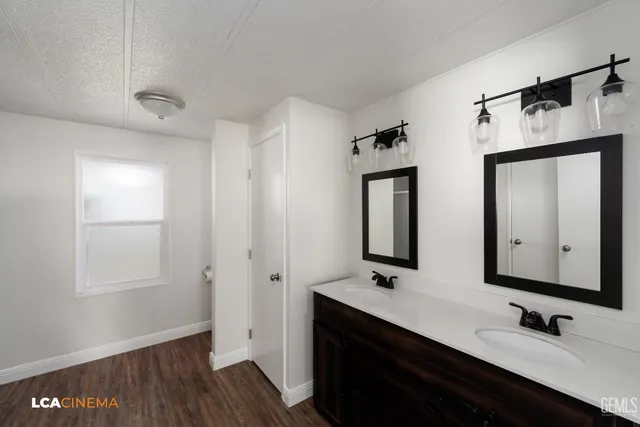 a bathroom with a double vanity sink and a mirror