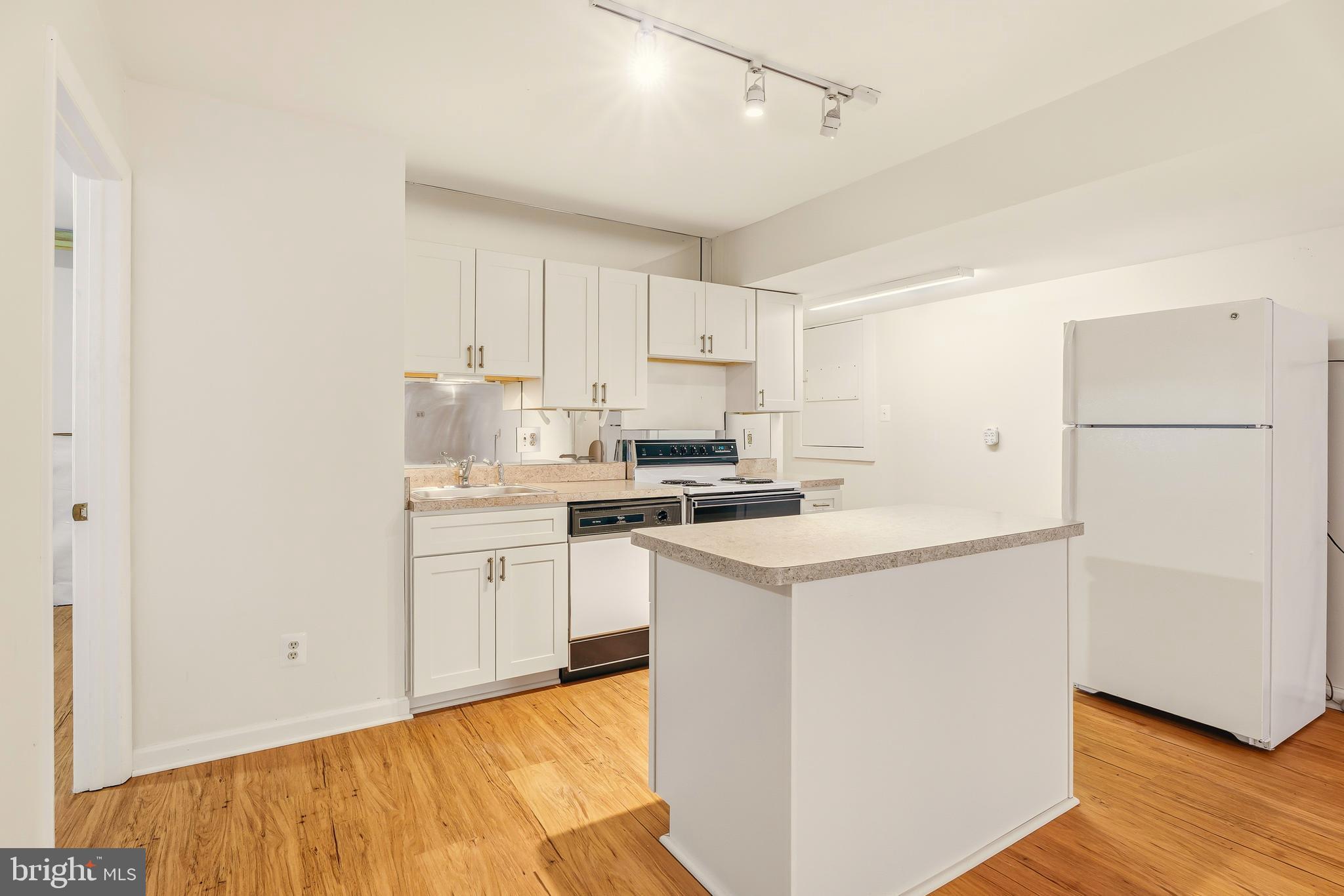 2 Riderwood Station Towson, MD 21204 - Photo 46 of 58 a kitchen with white cabinets and white appliances