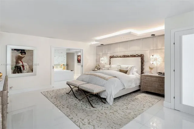 a bedroom with a bed and painting on the wall